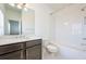 Clean bathroom with single vanity, shower/tub combo, and white subway tile at 601 Millcroft Blvd, Buford, GA 30518