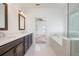 Spa-like bathroom featuring a soaking tub and double vanity at 601 Millcroft Blvd, Buford, GA 30518