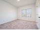 Bright and airy bedroom with neutral carpeting and large window at 601 Millcroft Blvd, Buford, GA 30518