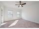Spacious bedroom with carpet flooring and ceiling fan at 601 Millcroft Blvd, Buford, GA 30518