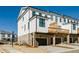 Rear view of townhome with private deck and two-car garage at 601 Millcroft Blvd, Buford, GA 30518