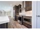 Modern kitchen with stainless steel appliances and dark cabinetry at 601 Millcroft Blvd, Buford, GA 30518