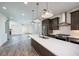 Open kitchen features stainless steel appliances and an island at 601 Millcroft Blvd, Buford, GA 30518