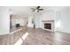 Open living room with hardwood floors and fireplace at 601 Millcroft Blvd, Buford, GA 30518