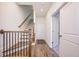 Modern staircase with dark metal railing and wood steps at 601 Millcroft Blvd, Buford, GA 30518