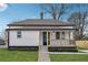 Charming white cottage with a black trim, landscaped yard, and a porch at 1617 Church Ne St, Conyers, GA 30012