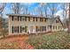 Two-story house with beige siding, black shutters, and landscaping at 2225 Mountain Creek Dr, Stone Mountain, GA 30087