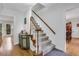 Bright entry with hardwood floors, a staircase with carpet runner, and classic white trim at 2225 Mountain Creek Dr, Stone Mountain, GA 30087