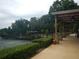 View of the community tennis courts with covered lounge area and manicured landscaping at 2225 Mountain Creek Dr, Stone Mountain, GA 30087