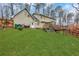 Spacious backyard with green lawn and view of the home's exterior at 2225 Mountain Creek Dr, Tucker, GA 30087