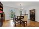 Elegant dining room with a chandelier, wood flooring, and a view of the backyard at 2225 Mountain Creek Dr, Tucker, GA 30087