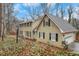 Side view of charming two-story home featuring an attached garage, a manicured lawn, and mature trees at 2225 Mountain Creek Dr, Tucker, GA 30087