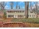 Beautiful two-story home with manicured lawn, brick accents, and mature trees at 2225 Mountain Creek Dr, Tucker, GA 30087