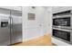Modern kitchen with stainless steel refrigerator and double ovens, plus hardwood floors at 2225 Mountain Creek Dr, Tucker, GA 30087