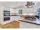 Well-equipped kitchen with stainless appliances, double ovens, gas cooktop and granite countertops at 2225 Mountain Creek Dr, Tucker, GA 30087