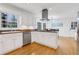 Bright eat-in kitchen with white cabinets, stainless appliances, granite countertops and hardwood floors at 2225 Mountain Creek Dr, Tucker, GA 30087