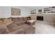Comfortable living room features a brick fireplace, built-in shelving, and a cozy brown sectional at 2225 Mountain Creek Dr, Tucker, GA 30087