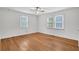 Spacious bedroom featuring hardwood floors, natural light, and neutral paint at 1049 Ferndale St, Stone Mountain, GA 30083