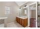 Bathroom with double vanity and wood cabinets at 4684 Pine Dr, Loganville, GA 30052