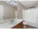 Clean bathroom with single sink vanity, shower/tub combo, and wood-look flooring at 4684 Pine Dr, Loganville, GA 30052