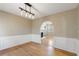 Bright dining room with hardwood floors and an archway to living room at 4684 Pine Dr, Loganville, GA 30052