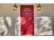 Red front door accented by black lanterns at 4684 Pine Dr, Loganville, GA 30052