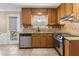 Kitchen features wood cabinets, granite countertops and stainless steel appliances at 4684 Pine Dr, Loganville, GA 30052