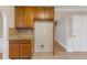 Kitchen with wood cabinets, granite countertops and access to hallway at 4684 Pine Dr, Loganville, GA 30052