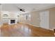 Spacious living room featuring hardwood floors, a fireplace, and built-in shelving at 4684 Pine Dr, Loganville, GA 30052