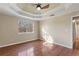 Main bedroom with hardwood floors and a tray ceiling at 4684 Pine Dr, Loganville, GA 30052