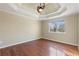 Main bedroom with hardwood floors and a tray ceiling at 4684 Pine Dr, Loganville, GA 30052