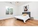 Bright bedroom with hardwood floors, a simple bed frame, and a picturesque window view at 500 Covington Cv, Alpharetta, GA 30022