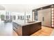 Spacious kitchen island with marble countertop and a view into the living room at 500 Covington Cv, Alpharetta, GA 30022