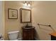 Classic powder room featuring wooden vanity with granite countertop and framed mirror, toilet, and hardwood style floors at 560 Glenmanor Ct, Atlanta, GA 30328