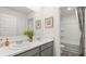 Bathroom with double vanity, gray cabinets, and a shower/tub combo at 652 Kimberwick Dr, Locust Grove, GA 30248