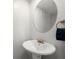 Simple bathroom with pedestal sink and round mirror at 3301 Henderson Mill Rd # A2, Atlanta, GA 30341