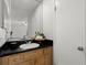 Bathroom with wood vanity and black countertop at 3301 Henderson Mill Rd # A2, Atlanta, GA 30341