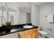 Bathroom with wood vanity, black countertop, and shower at 3301 Henderson Mill Rd # A2, Atlanta, GA 30341