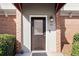 Dark brown front door with sidelights and red awning at 3301 Henderson Mill Rd # A2, Atlanta, GA 30341