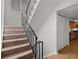 Carpeted stairs with metal railing leading upstairs at 3301 Henderson Mill Rd # A2, Atlanta, GA 30341