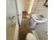 Bathroom includes a bathtub, sink, and toilet at 5039 East St, Forest Park, GA 30297