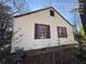 Side view of the house, light yellow siding at 5039 East St, Forest Park, GA 30297