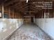 Large empty garage with concrete floor and shelving at 5039 East St, Forest Park, GA 30297
