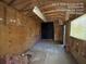 Unfinished garage with concrete floor and wood paneling at 5039 East St, Forest Park, GA 30297