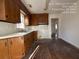 View of kitchen with wood cabinets and vinyl flooring at 5039 East St, Forest Park, GA 30297