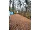 Large backyard with leaf covered ground and distant homes visible at 7035 Stone Wood Nw Dr, Kennesaw, GA 30152