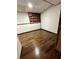 Finished basement room with dark wood-look floors and built-in shelving at 7035 Stone Wood Nw Dr, Kennesaw, GA 30152