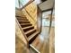 Basement stairs with wood-look flooring and wood paneling at 7035 Stone Wood Nw Dr, Kennesaw, GA 30152