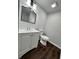 Basement bathroom with white vanity, toilet, and shower at 7035 Stone Wood Nw Dr, Kennesaw, GA 30152