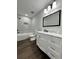 Updated bathroom with white cabinets, marble shower, and dark brown flooring at 7035 Stone Wood Nw Dr, Kennesaw, GA 30152